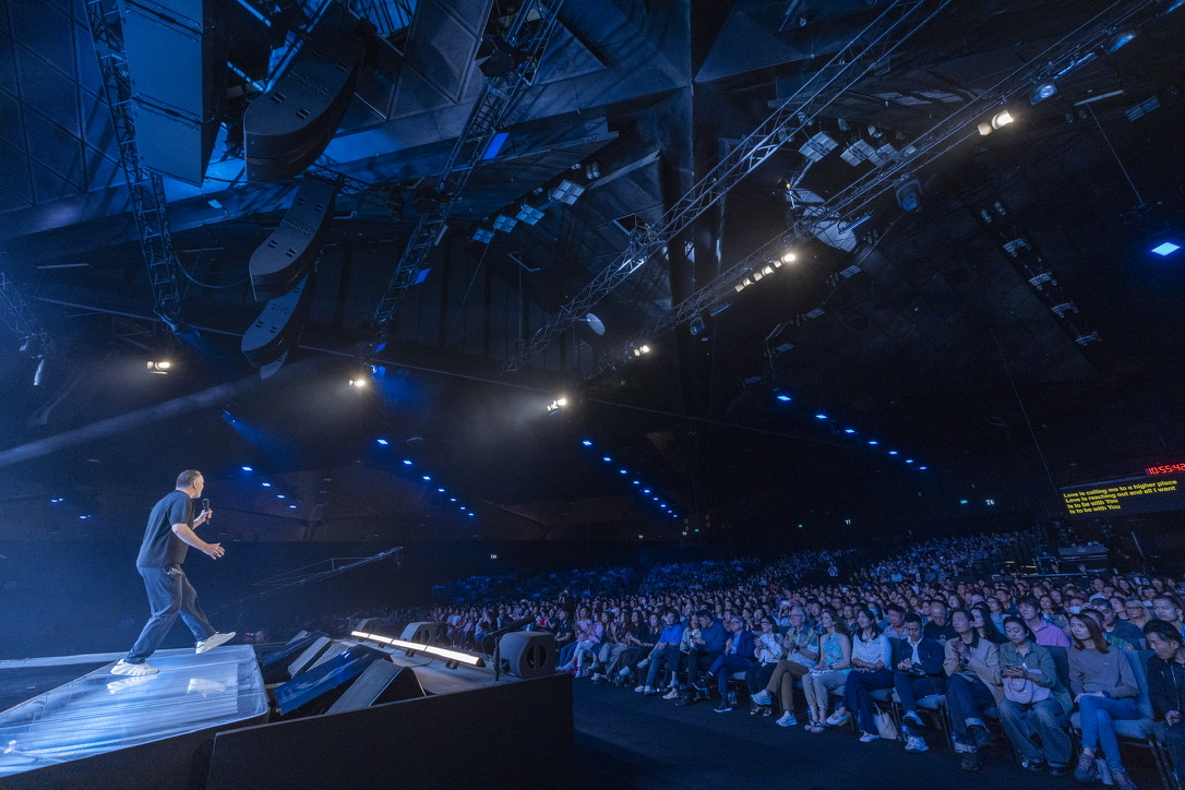 Mark Stevens ministering to a gathered congregation
