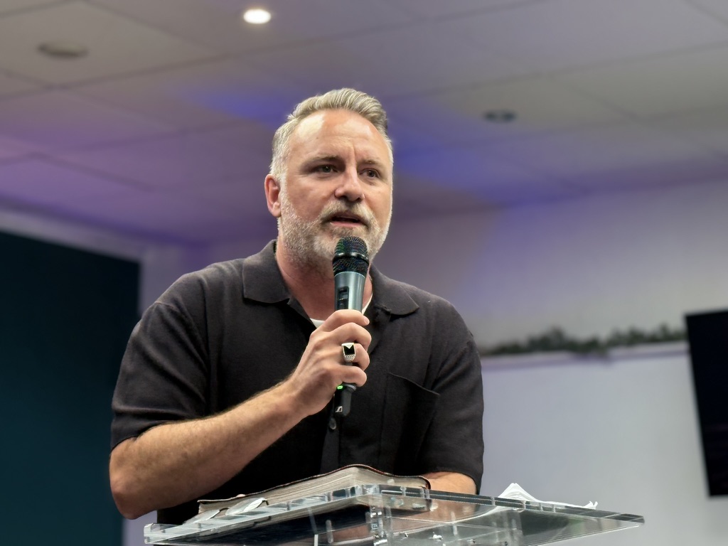 Mark teaching with a microphone